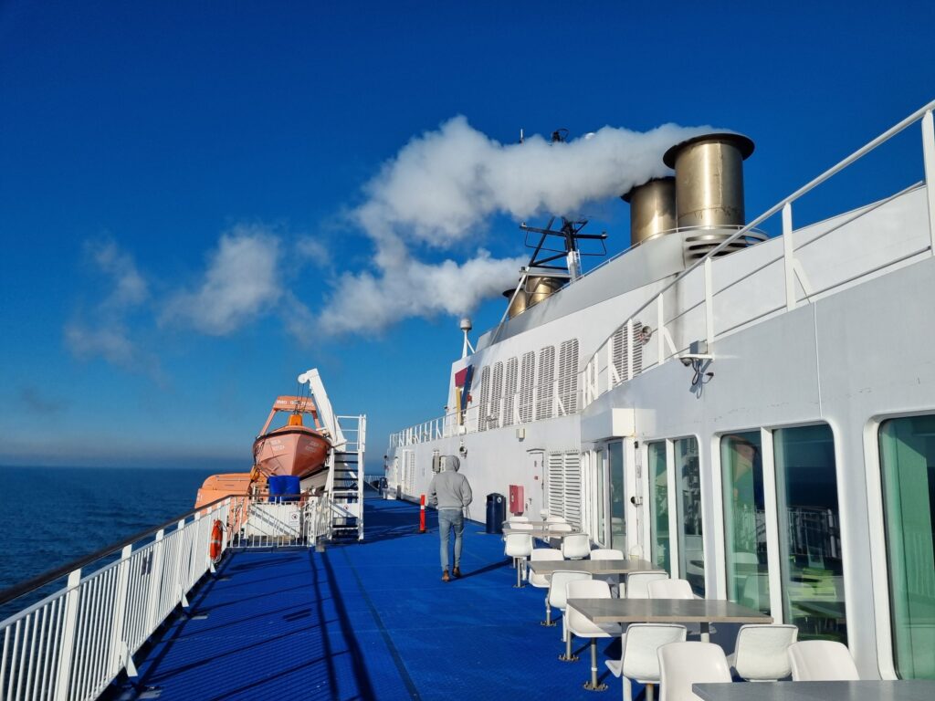 Outer deck of the ferry Berlin with seating and funnels