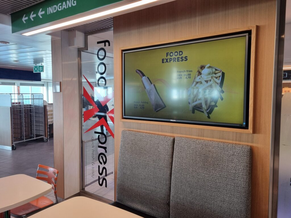 Screen at Food Express on the ferry Berlin showing hotdog and fries at 35 kroner or 4.70 euros